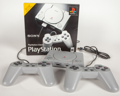 Playstation classic console with two controllers and front of packaging.