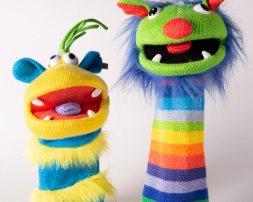 Two colorful and fuzzy monster hand puppets.