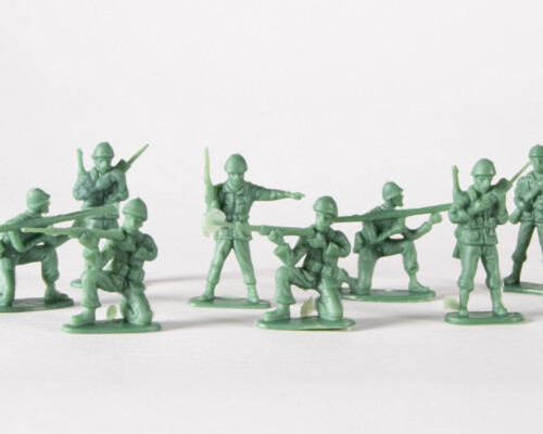 Green army men, posed with rifles, bazookas, and radios.