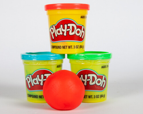 Red Play-Doh ball and three Play-Doh containers.