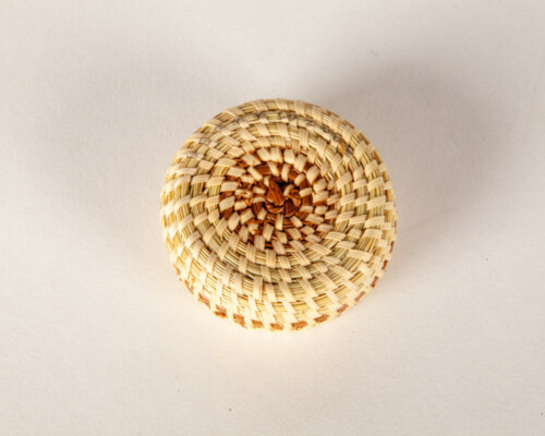 Close up of small woven sweetgrass basket.
