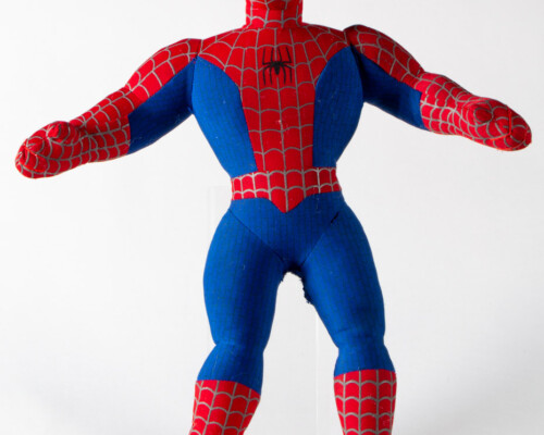 Front view of stuffed spider man toy. Blue and red suit with web and spider pattern.