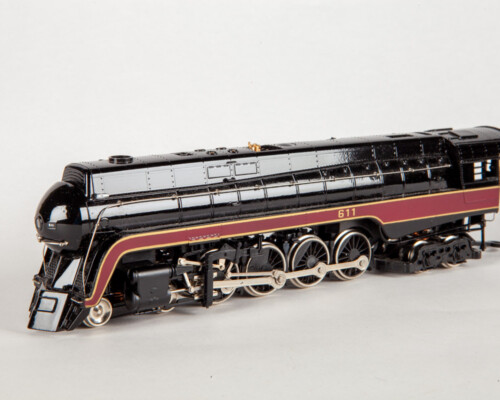 Side view of black and red train with gold and silver accents.