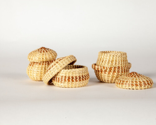 Three small sweetgrass baskets with lids.